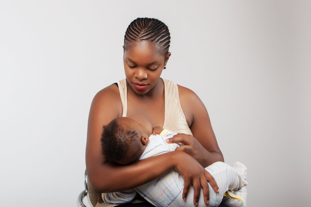 African american woman breastfeeding her baby to lose weight. 